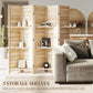 Wood slatted folding room divider with three storage shelves beside a sofa