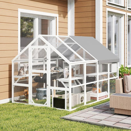 White outdoor wooden cat enclosure with gray roof and enclosed multi-level play area