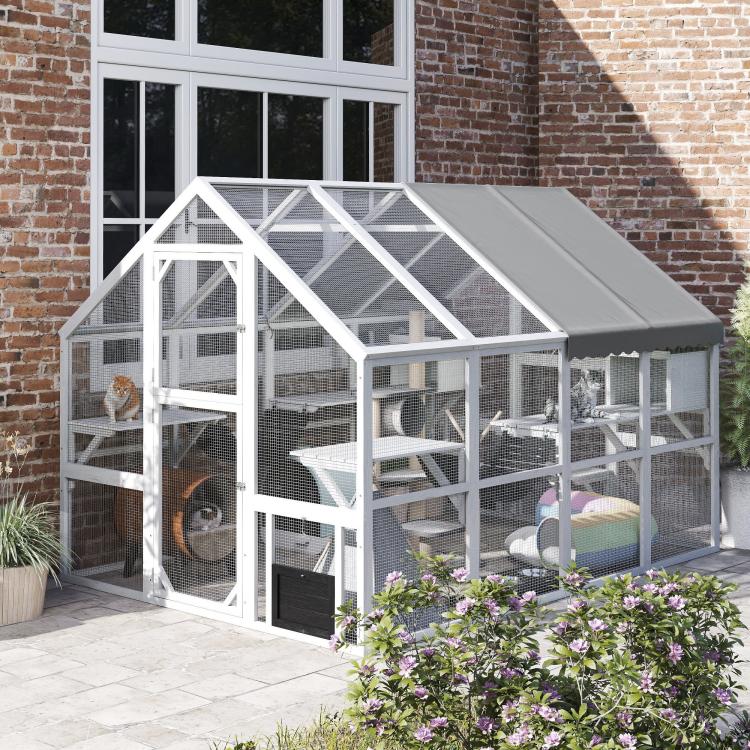 White outdoor wooden cat enclosure with gray roof and enclosed multi-level climbing areas