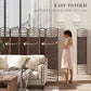 Brown 8-panel folding room divider being unfolded beside sofa and curtains