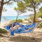 Two-person outdoor hammock with navy fabric and blue pillow, rope suspension