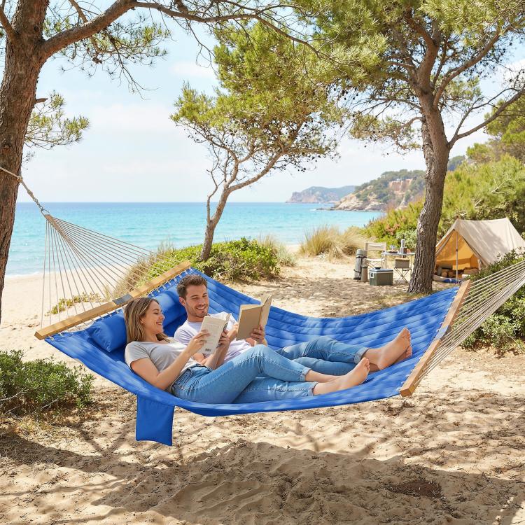 Two-person outdoor hammock with navy fabric and blue pillow, rope suspension
