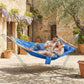 Two people relaxing in a blue two-person hammock with built-in pillow