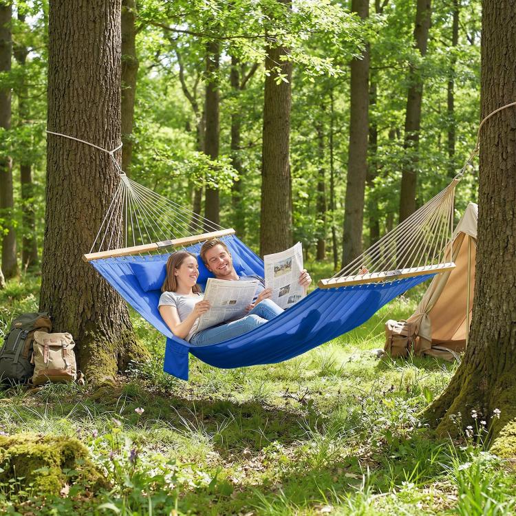 Blue two-person hammock with wooden spreader bars, two campers reading