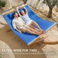 Extra-wide blue two-person hammock with built-in pillow, two people lounging