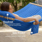 Blue hammock with headrest and side pocket, woman reclining