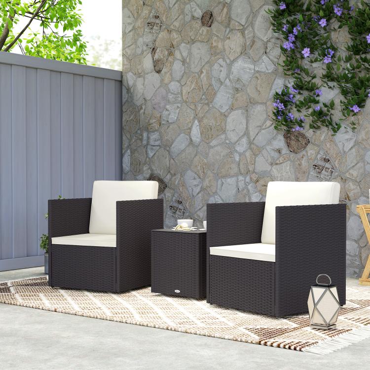 3-piece wicker bistro set with two dark woven chairs and cream seat cushions