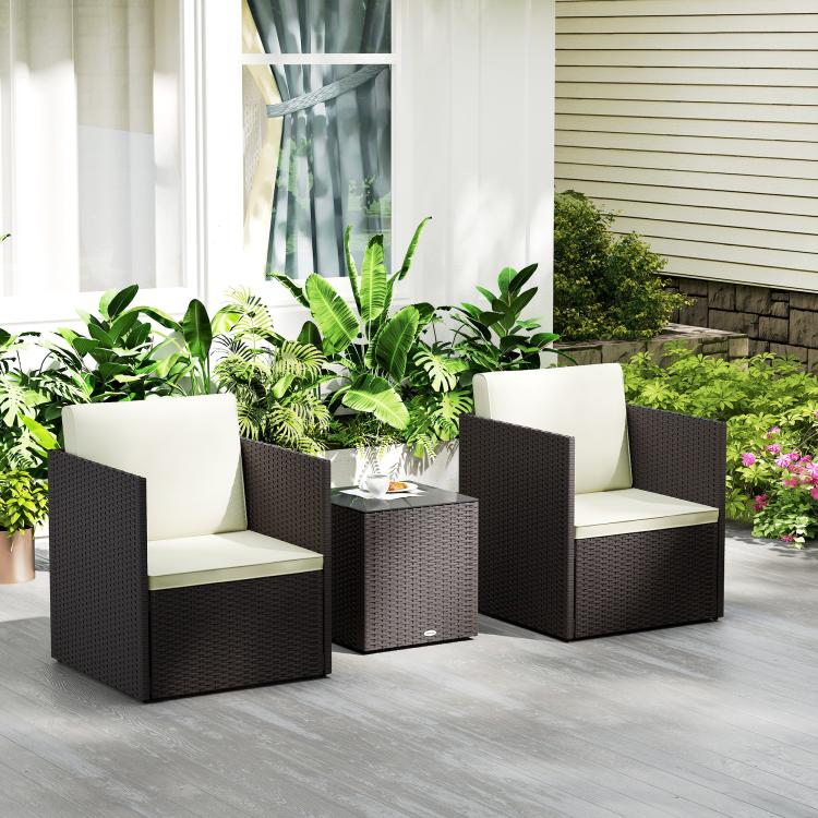 Outdoor wicker bistro set with two armchairs and square table, cream cushions