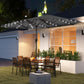 Gray patio parasol with LED lights over outdoor dining area
