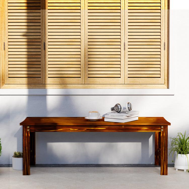 Backless wood bench with slatted seat and dark brown finish against a wall