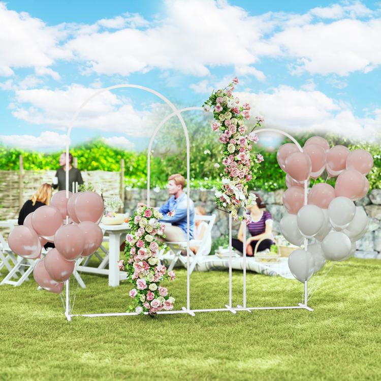 White metal backdrop arch frame set with pink and white balloons and flower arrangement