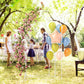 White metal backdrop arch frame with pink flower garland and balloon decorations