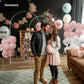 White metal backdrop arch frame with floral decor and pastel balloon clusters