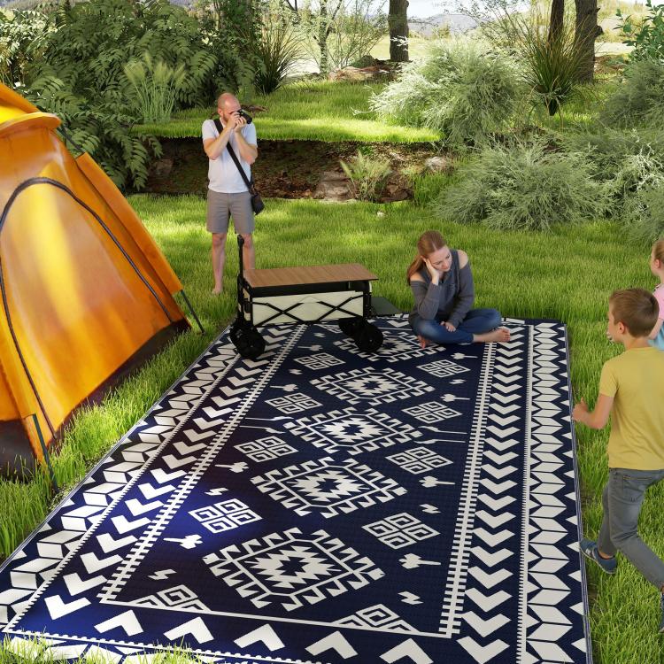Blue-and-white outdoor rug with bold tribal diamond and zigzag stripe patterns