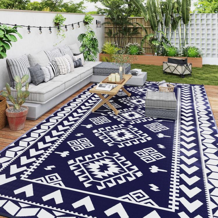 Outdoor rug with blue center field and white geometric border accents