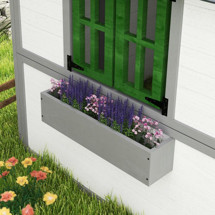 Kids wooden playhouse front with flower planter boxes and green shutters, white frame