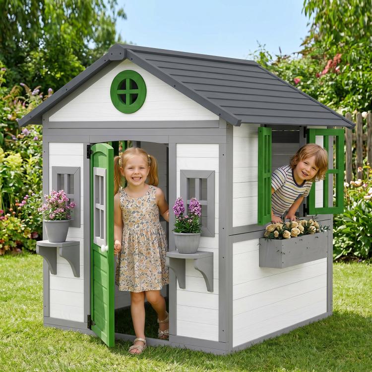 Outdoor white wooden playhouse with green door and two windows, with planter boxes