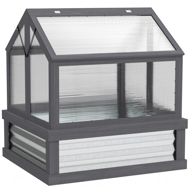 Gray raised garden flower bed with greenhouse cold frame and clear plastic panels