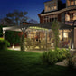 Gray outdoor wooden pergola with illuminated lights over patio seating at night
