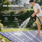 Reversible outdoor rug with blue-and-white geometric pattern, used outdoors