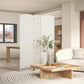 White woven 3-panel folding privacy screen standing between sofa and coffee table