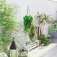 White vertical plant stand with trellis grid, hanging chain, and bottom shelf for pots