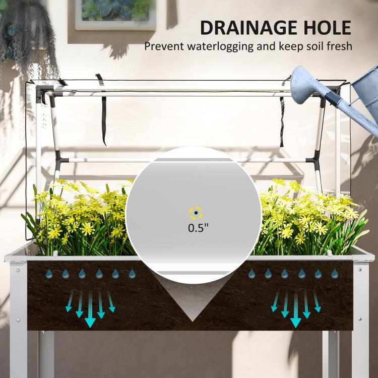 White raised garden bed with clear cover showing drainage hole for watering