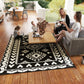Black and white geometric outdoor rug with diamond and zigzag patchwork pattern