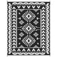 Black and white reversible geometric outdoor rug with diamond medallion pattern