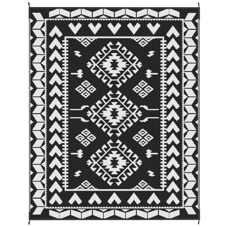 Black and white reversible geometric outdoor rug with diamond medallion pattern
