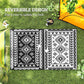 Reversible outdoor rug with two black-and-white patterned sides
