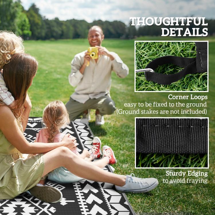 Outdoor reversible rug with black-and-white geometric pattern and edge details