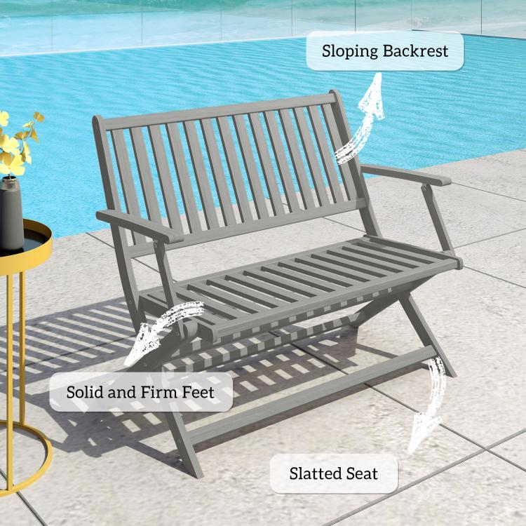 Gray bench with slatted seat, sloping backrest, and sturdy flat feet