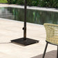 Square metal umbrella stand base on patio with pole support and side knob