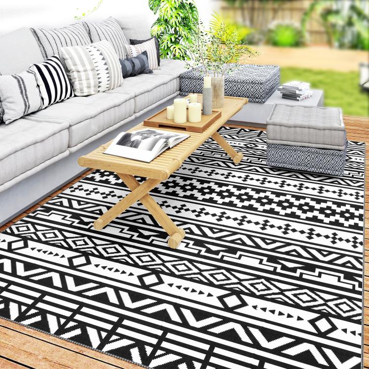 Black-and-white geometric outdoor rug with flat woven pattern