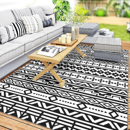 Black-and-white geometric outdoor rug with flat woven pattern