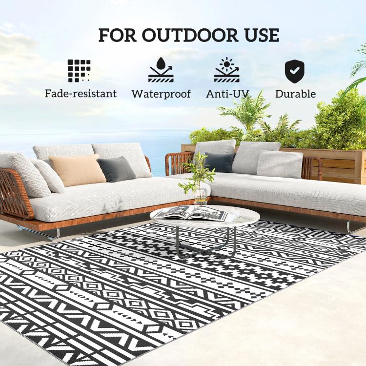 Black-and-white geometric outdoor rug under outdoor sofa seating