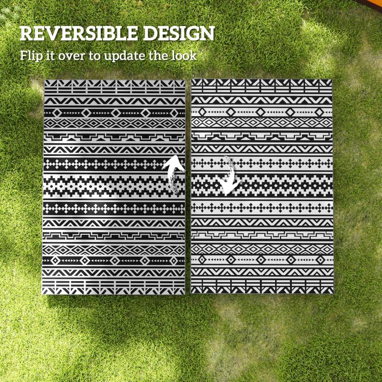 Reversible black-and-white geometric outdoor rug, two pattern sides