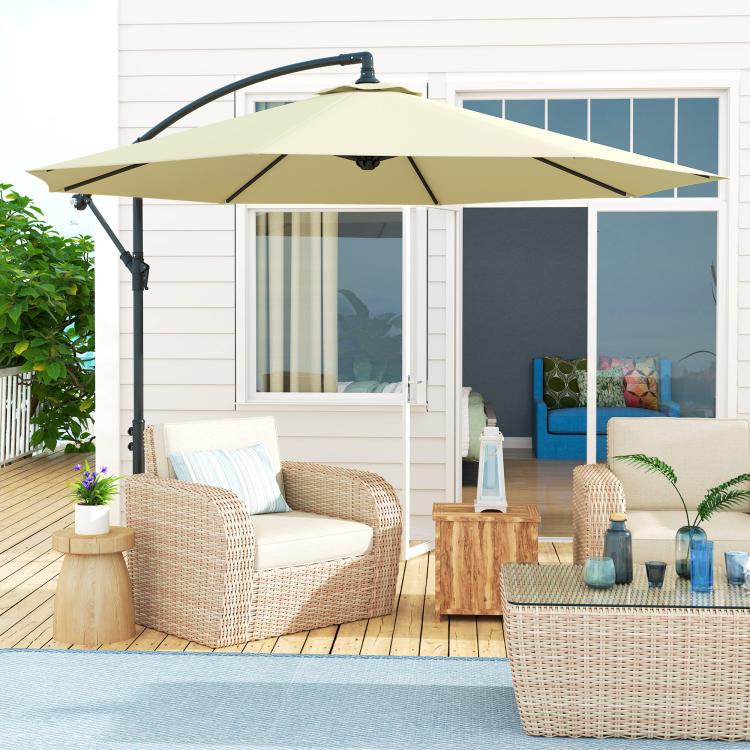 Beige cantilever umbrella over outdoor seating area on a patio deck.