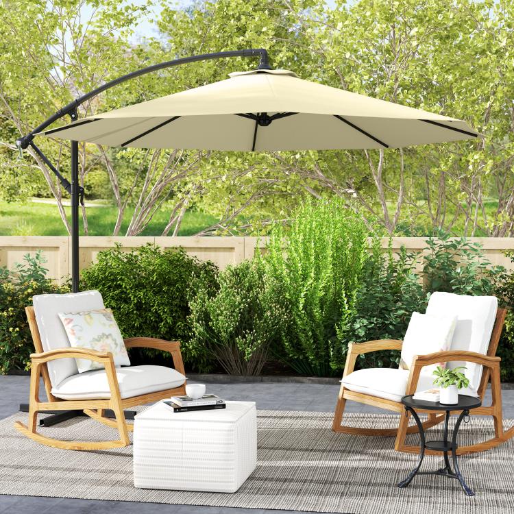 Beige patio umbrella over outdoor chairs with black cantilever stand.