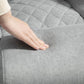 Gray fabric office chair seat with diamond quilt texture, close-up