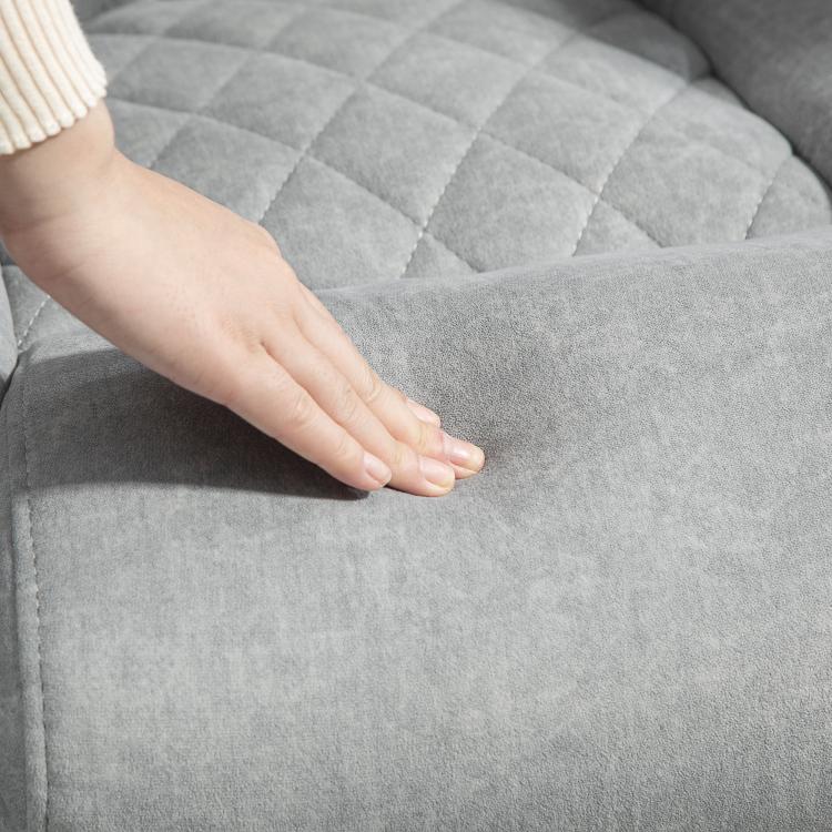 Gray fabric office chair seat with diamond quilt texture, close-up
