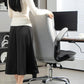 Gray chair with flip-up armrest and padded seat cushion on chrome base