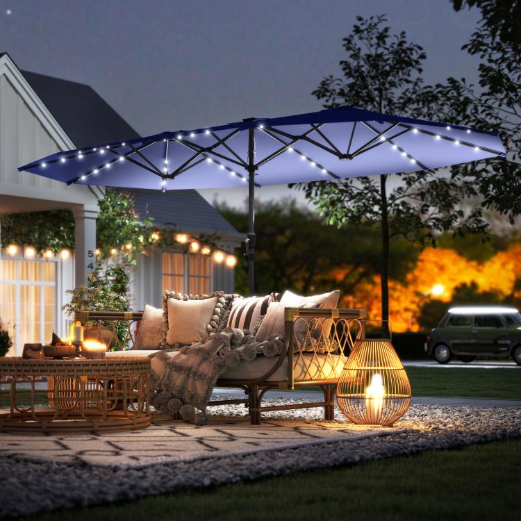 Navy patio umbrella with LED light strings across the canopy for outdoor lounge
