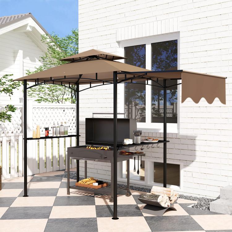 Brown grill gazebo shelter with side awning and dark metal frame beside a brick patio