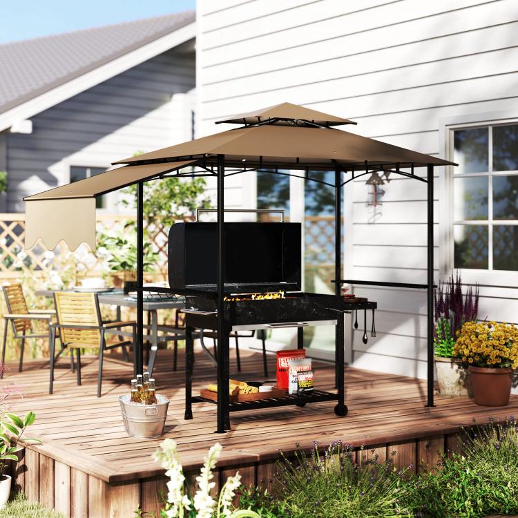 Brown outdoor grill gazebo with dark metal frame on a wooden deck, open sides for grilling