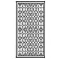 Reversible outdoor rug shown flat with black-and-white clover trellis design