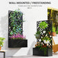 Black metal planter box with privacy screen and layered flower arrangement