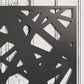 Close-up of black decorative metal privacy screen with geometric cutouts