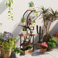 S-shaped plant stand with dark metal frame and wood tiers holding potted plants